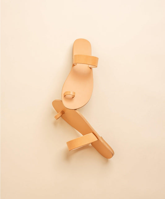 Elegant flat sandals in camel against a beige background. Part of our flat footwear for womens collection.