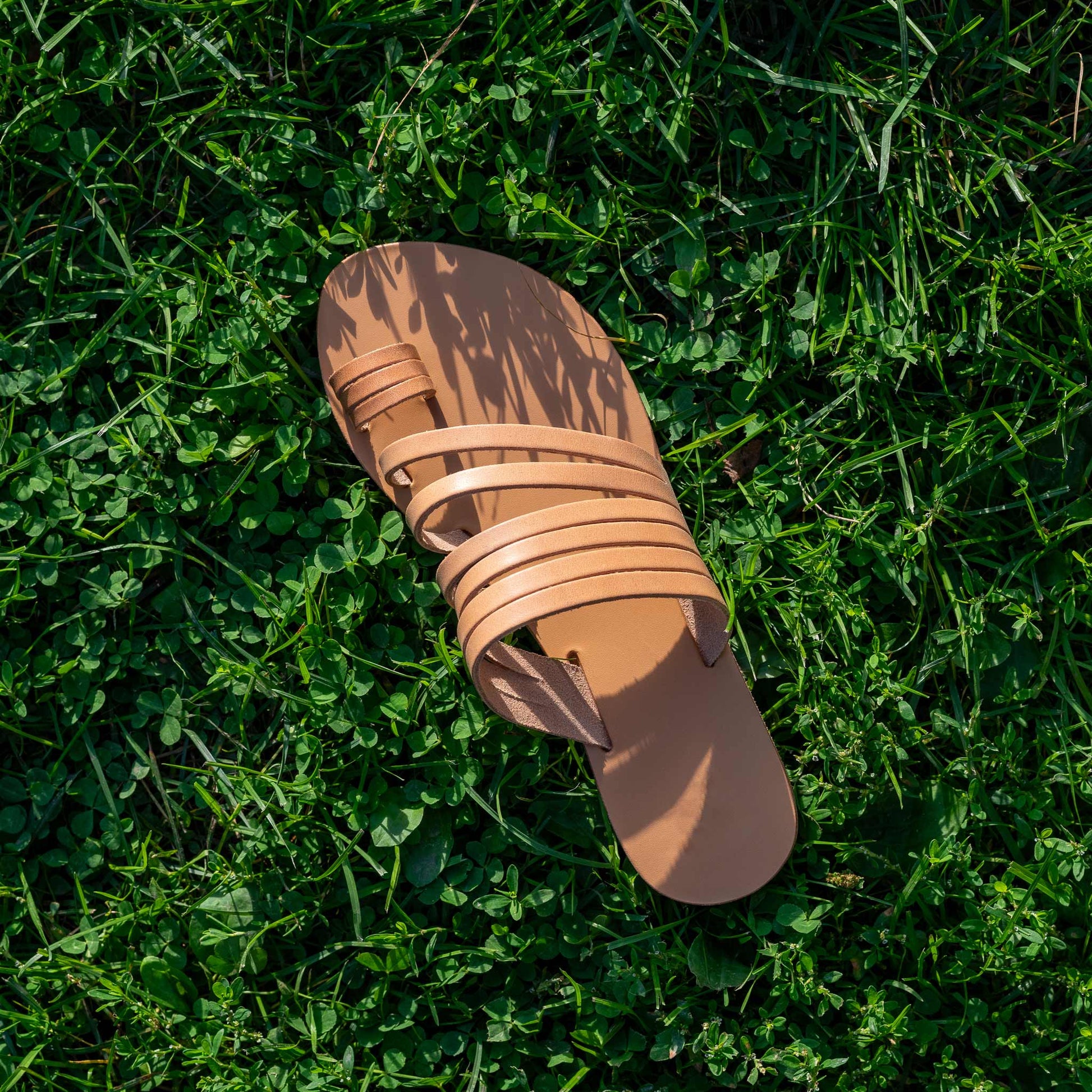 Helen slide on flats in tan on green grass. They are slip on flats womens.