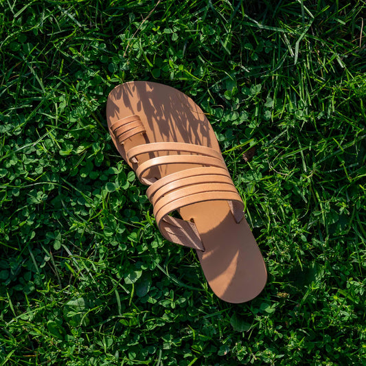 Helen slide on flats in tan on green grass. They are slip on flats womens.