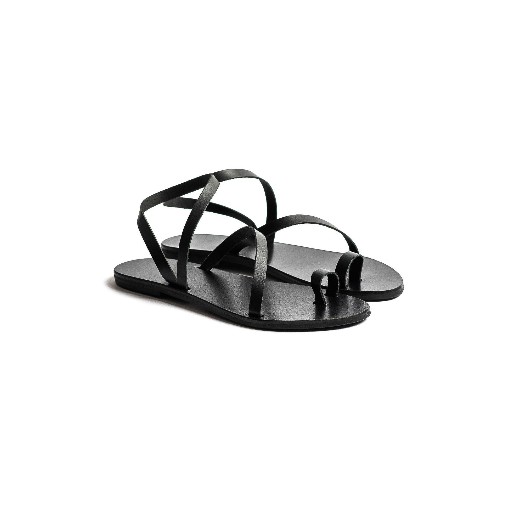 Pair of black flats sandals on a white background-side view