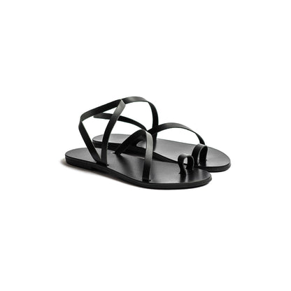 Pair of black flats sandals on a white background-side view
